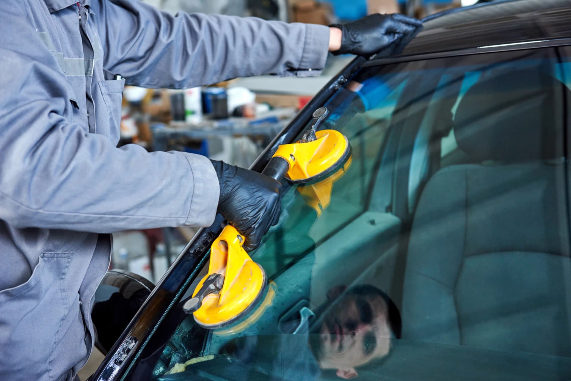 Technician repairing a car windscreen